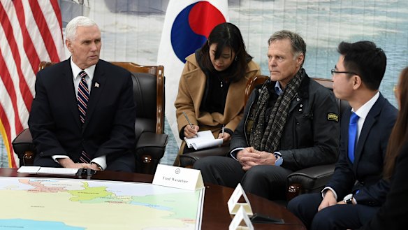 US. Vice President Mike Pence, left, talks with North Korean defector Ji Seong-ho, right, as Fred Warmbier, the father of Otto Warmbier, an American who died after being held in North Korea, listens at the Cheonan Memorial in Pyeongtaek, South Korea in February.