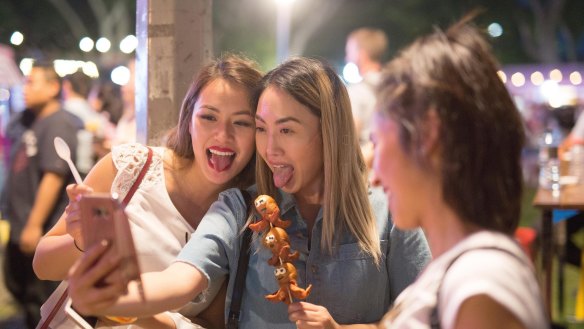 Friends pull faces for a selfie at the Night Noodle Markets in 2016.