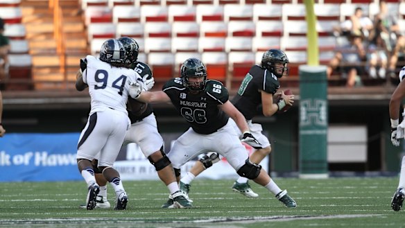 Blake Muir, wearing No.66, playing for the University of Hawaii college football team. 