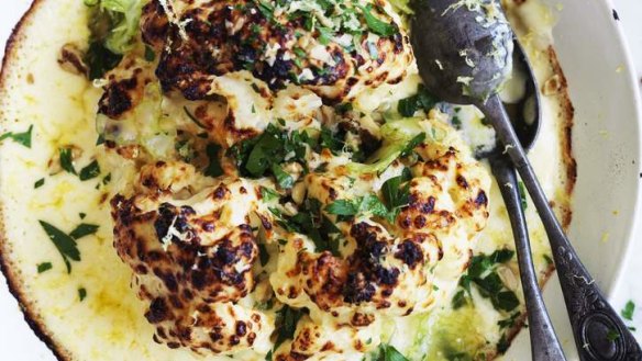Whole cauliflower gratin with pickled celery and walnuts.