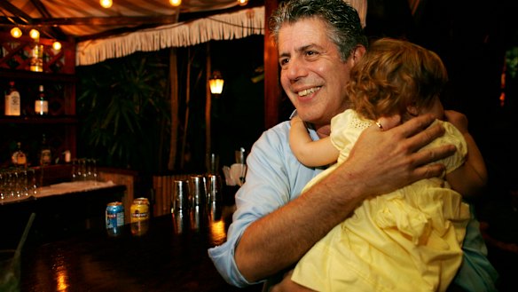Anthony Bourdain holds his daughter Ariane in Miami Beach in 2008.