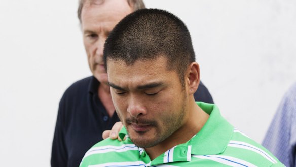 Andrew Chan's brother, Michael, holds back tears.