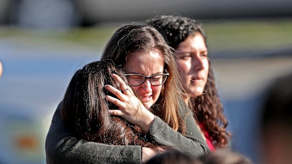 Students released from a lockdown embrace following following a shooting at Marjory Stoneman Douglas High School in Parkland, Florida. 