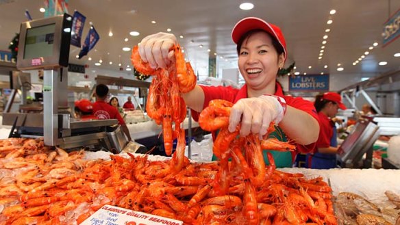 Bucketloads of prawns ... Tran Nguyen of Claudio's shows off large cooked tiger prawns from the Clarence River.