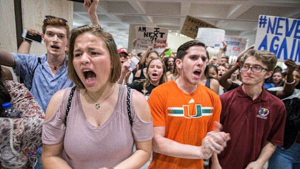 Students chant protest slogans outside the Florida House of Representatives chamber inside the Florida Capitol.