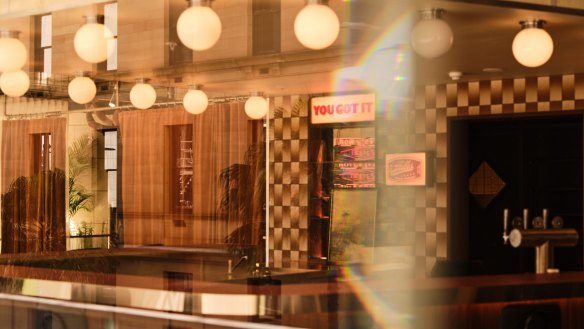 Drapes, vintage tiling and retro lighting feature in the space.