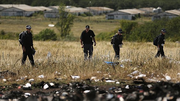Australian Federal Police and their dutch counterparts search the MH17 crash site for human remains in 2014.