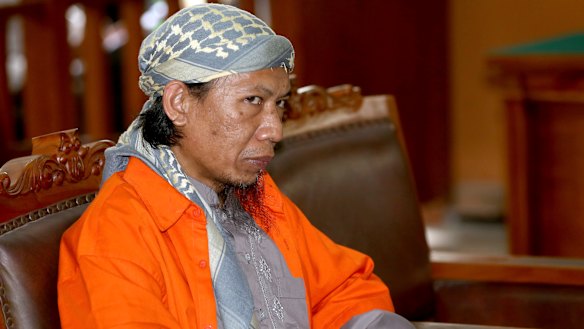 Indonesian militant Oman Rohman, popularly known as Aman Abdurrahman, sits on the defendant's chair during his trial.