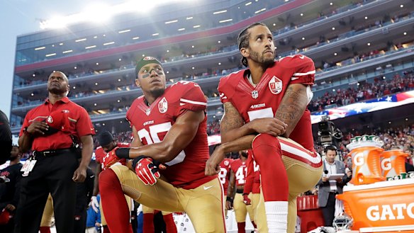 Taking a stand: San Francisco 49ers safety Eric Reid and former quarterback Colin Kaepernick kneel during the national anthem in protest of treatment of black people by police.