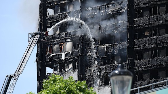 Fire fighters toil fruitlessly to quell the flames in the 24-storey Grenfell Tower in  West London.