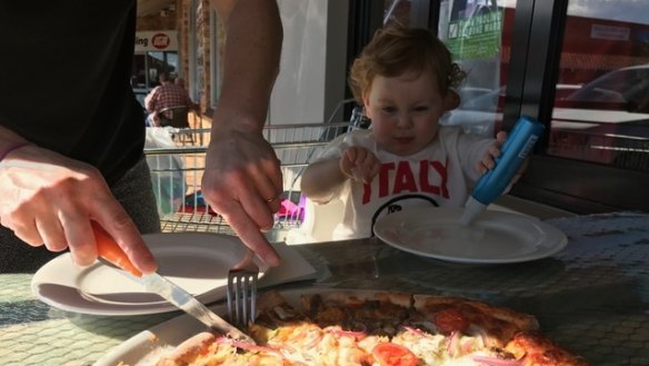#4: Little Edith P enjoying a slices of Amica Cafe pizza.