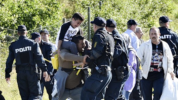 Danish police clash with one of about 300 migrants in September. 