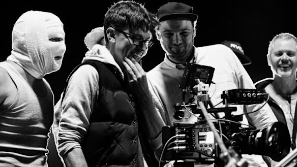 On set ... director Abe Forsythe (second from left) watches a take with actor Justin Rosniak, director of photographry Lachlan Milne and stunt co-ordinator Tony Lynch.