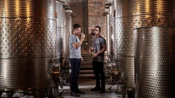 Archie Rose founder Will Edwards (left) inspects the product with head distiller Joe Dinsmoor.