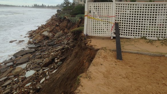 Houses teeter on the edge of a cliff after the Collaroy storm disaster. 