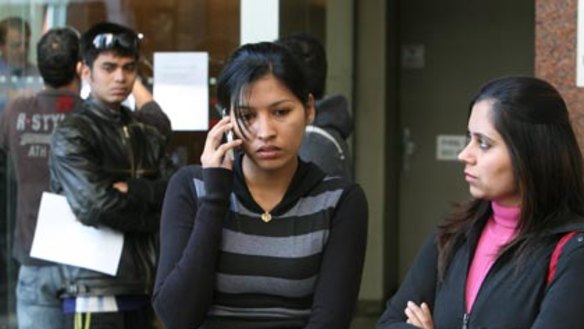 Nowhere to turn....shocked students wait for an explanation outside the locked doors of the Sterling College building in Market Street yesterday.