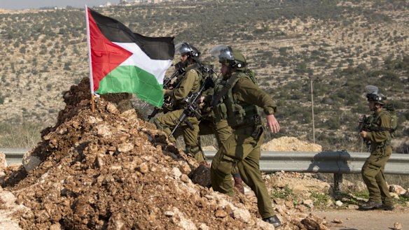 Israeli troops advance toward Palestinian demonstrators near the occupied West Bank village of Aboud, near Ramallah.