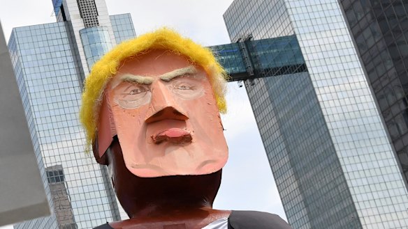 People march with a giant puppet of U.S. President Donald Trump during a demonstration in Brussels,