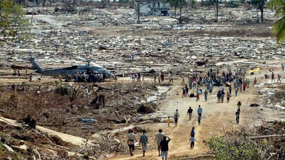 Aid effort: Indonesian tsunami survivors receive food and water from a US helicopter after the 2004 Boxing Day tsunami.
