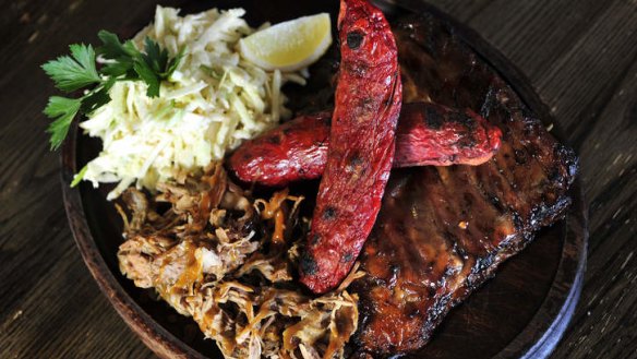 The Beast of Burley mixed grill includes pork ribs, pulled pork, andouille sausage and slaw.