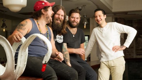 From left: Jake Smyth, Oscar McMahon, Kenny Graham and Elvis Abrahanowicz with a tyre swan in The Unicorn hotel, opening Tuesday.