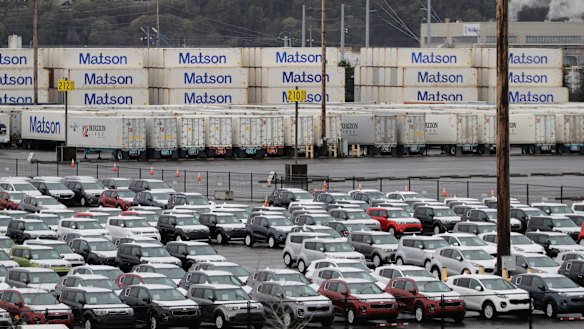 New cars and cargo containers wait in Tacoma, Washington.