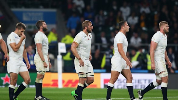 Dejected: The England team after their loss to the Wallabies.