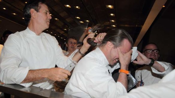 US chef Thomas Keller lops Neil Perry's ponytail for $50,000 for the Starlight Foundation.