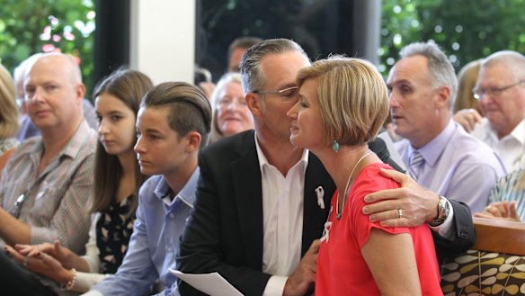Remembered: Kathryn Szyszka is comforted by her husband Walter Szyska after speaking at the first community memorial service for her sister, Anita Cobby.