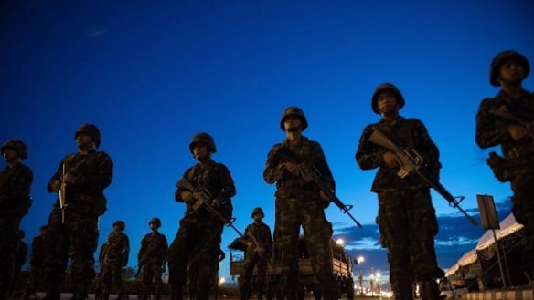 Thai army soldiers stand guard at the main entrance of the pro-government ''Red Shirts'' rally site after they shut it down and cleared protesters from the site.