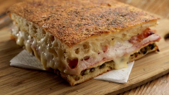 Muffaletta focaccia filled with cheese and cured meats.