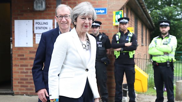 Conservative Party leader Theresa May and husband Philip arrive at a polling station to vote on Thursday.