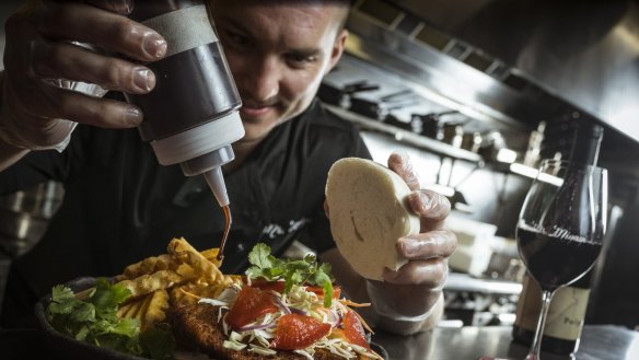 Mr Miyagi cook Matt Schultz prepares their chicken schnitty bao burger and waffle fries, which will be showcased at the Melbourne Night Noodle Market.  