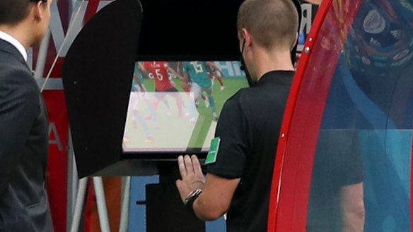 New era: Referee Mark Geiger using VAR in the match between South Korea and Germany.