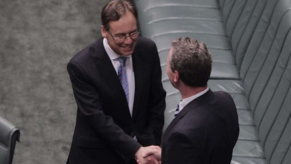 Environment Minister Greg Hunt is congratulated by Leader of the House Christopher Pyne after the Carbon Tax Repeal bills passed the House on the voices at Parliament House on Thursday 21 November 2013. Photo: Andrew Meares