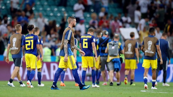 Sweden players walk off the pitch  after their last-minute loss to Germany.