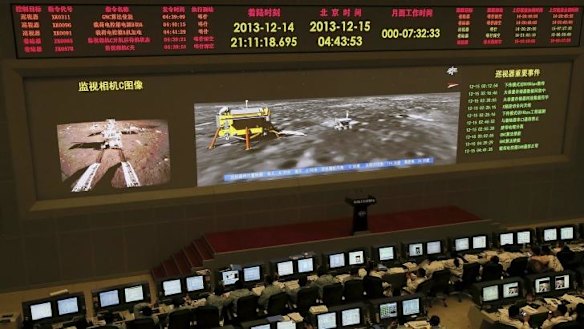 Researchers work in the control room of the Chang'e-3 lunar probe after it landed on the moon and deployed a moon rover, at the Beijing Aerospace Control Center in Beijing.