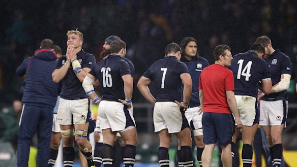 Heartbreak: Scotland react after Bernard Foley's last-gasp penalty.