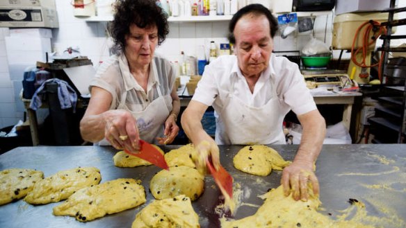 The pair divide the mixture, before pouring it into cases ready for baking.