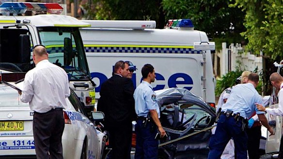 Crash scene … the wreckage after a police vehicle crashed into an elderly woman's car at Bankstown yesterday.