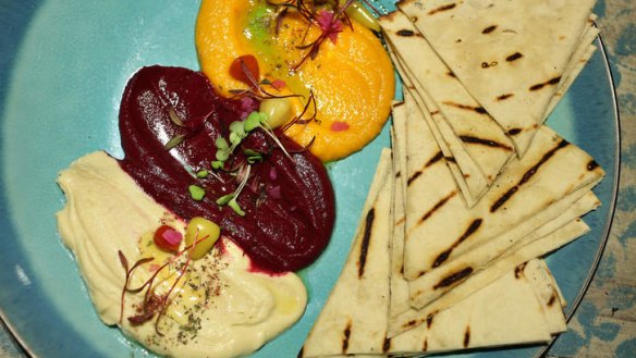 The mixed dip plate of beetroot, carrot and hummous, served with warm pita bread.