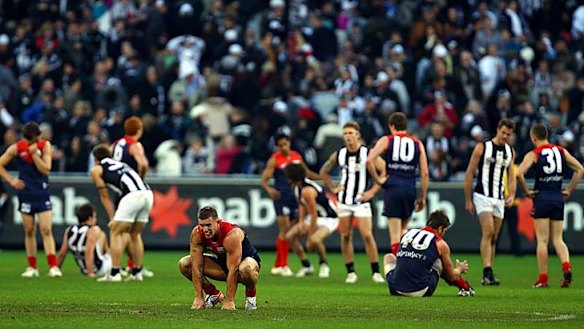 Melbourne and Collingwood contemplate their draining draw, round 12, 2010.