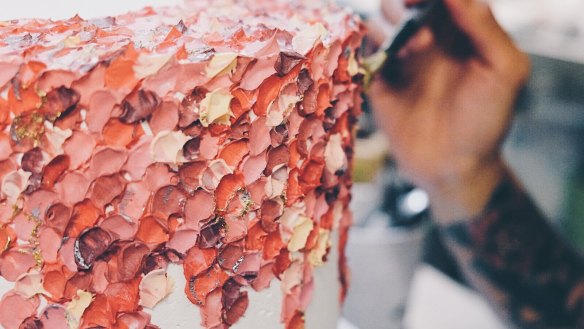 Kat Logan creating one of her painted cakes. 