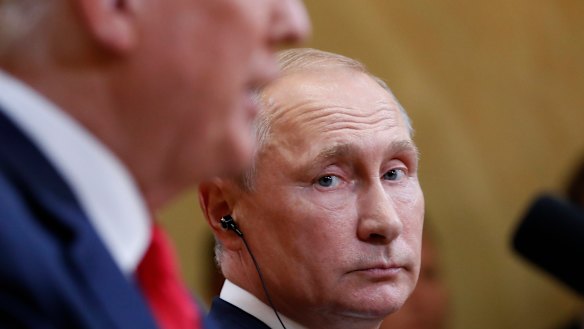 Russian President Vladimir Putin listens to US President Donald Trump 
