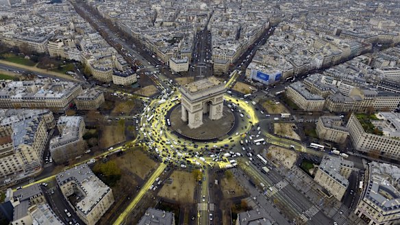 The Arc de Triomphe roundabout painted yellow by climate change activists during the Paris conference.