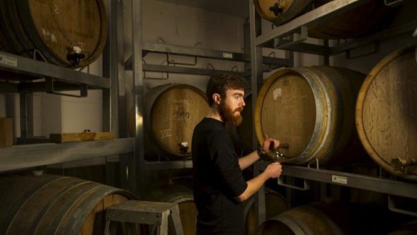 Wig and Pen duty-manager, Finn McGrath in the brew-pub's barrell-aging room, in the basement of Canberra House. The brewery plans to move to Llewellyn Hall.