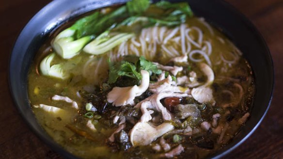 Noodle soup with pickles and deep-fried pork.