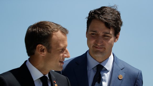 French President Emmanuel Macron is greeted by Canadian Prime Minister Justin Trudeau
