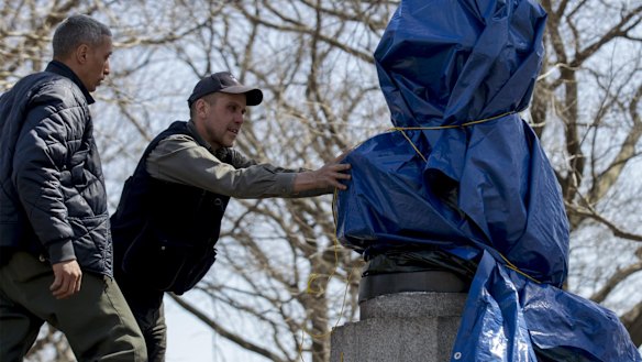 New York City Parks workers remove a moulded bust of Snowden that was erected by a group of anonymous artists in 2015.