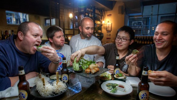 Chef Adam D'Sylva serves some dude food to Coda staff members Matthew Lawdorn, Joel Crowther, Henri Budiman and Alan Timu.